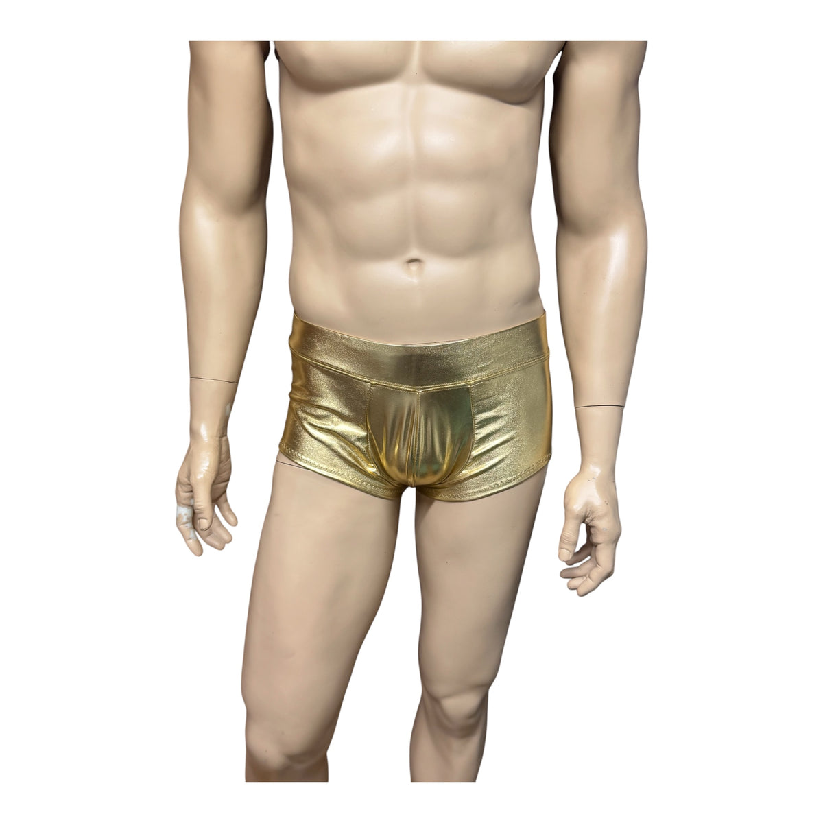 Front view of a mannequin wearing men's metallic gold booty shorts, showing the short leg length against a white background.