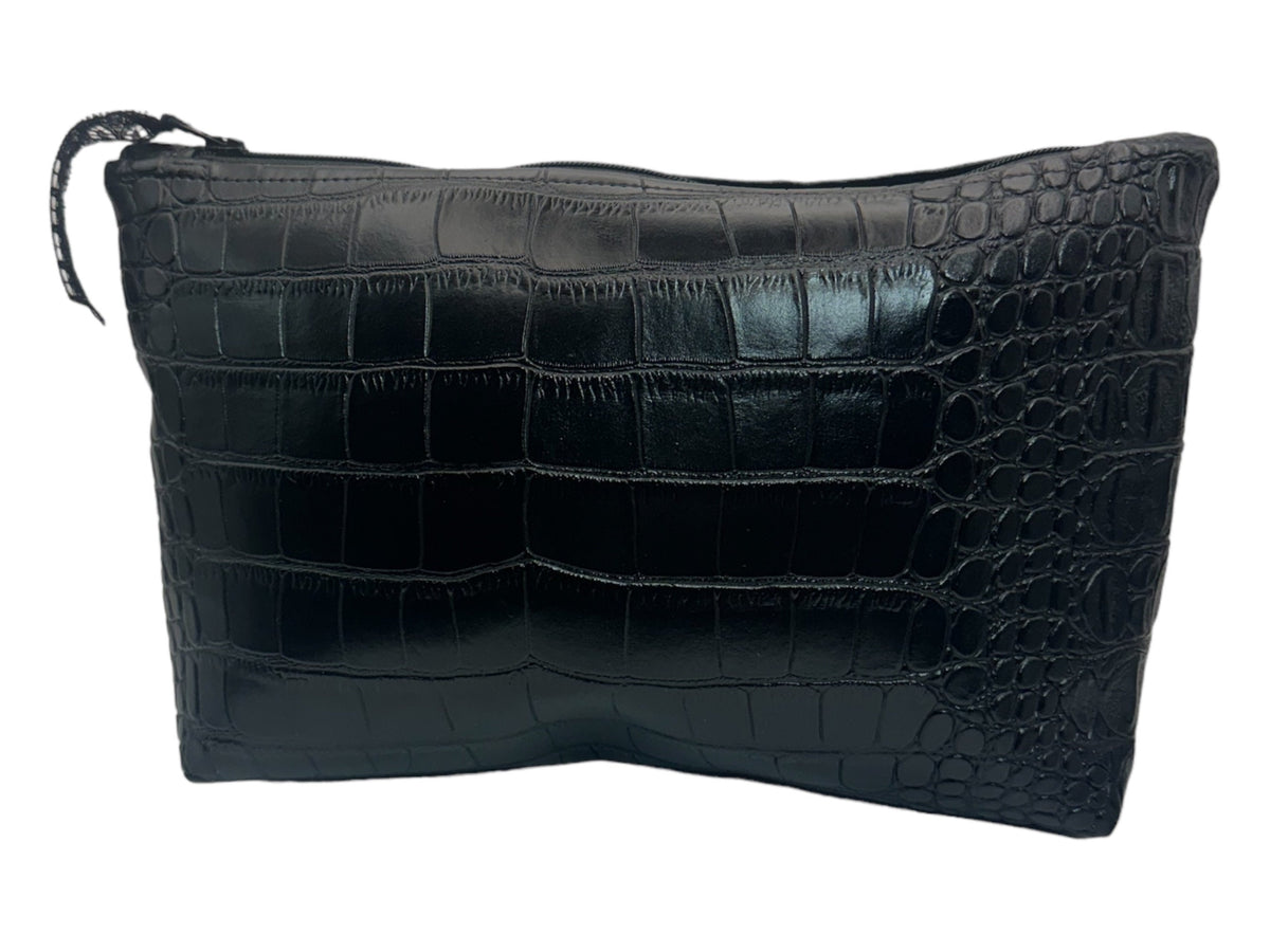 Close-up of a black faux crocodile leather cosmetic bag showing the glossy embossed reptile pattern, textured surface, and rectangular zippered pouch design.