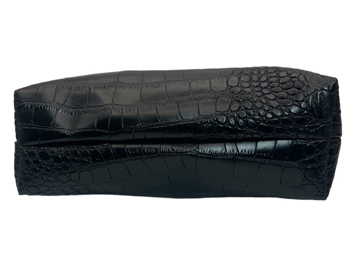 Bottom view of a handmade black faux crocodile cosmetic bag showing the rectangular base, stitched seams, and glossy textured material.