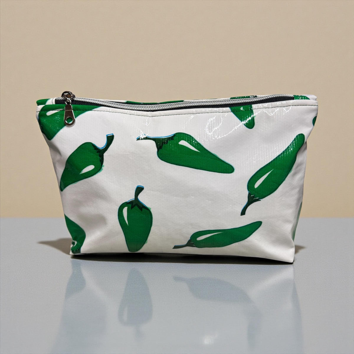 Handmade white makeup bag with green chili pepper print and zipper closure