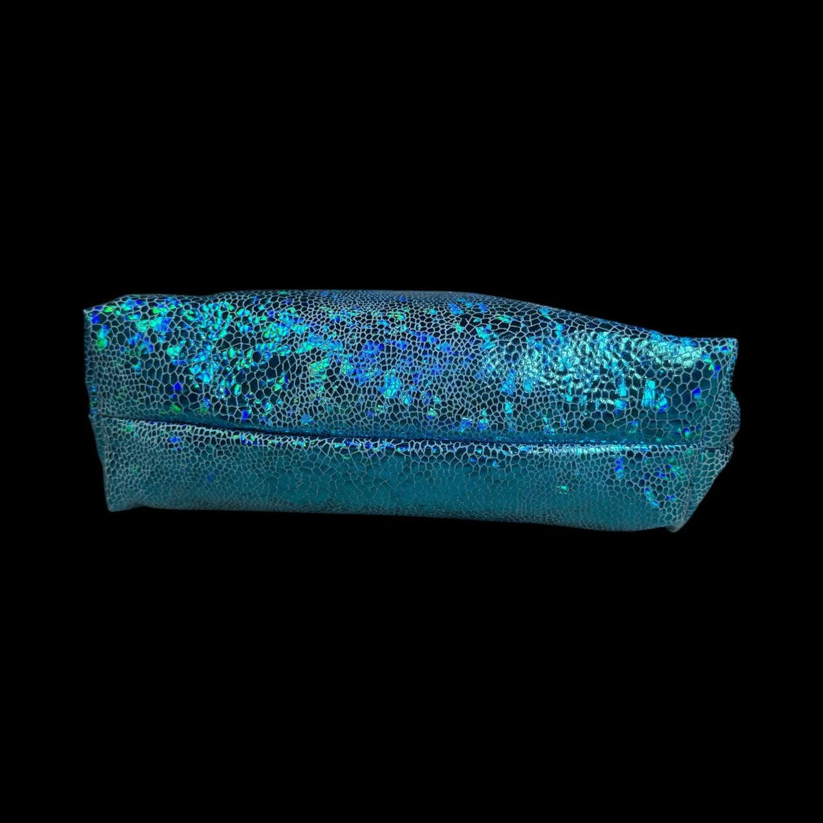 Side view of handmade blue holographic zipper pouch showing its slim profile